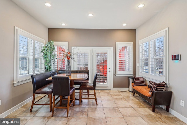 dining space featuring light tile patterned flooring