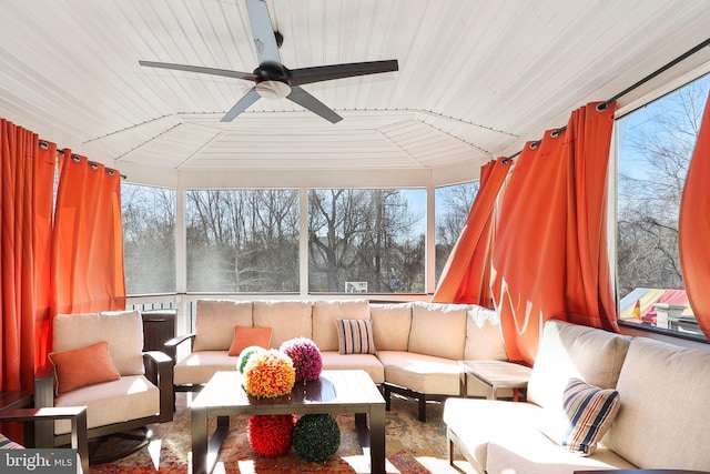 sunroom with wood ceiling, a wealth of natural light, and ceiling fan