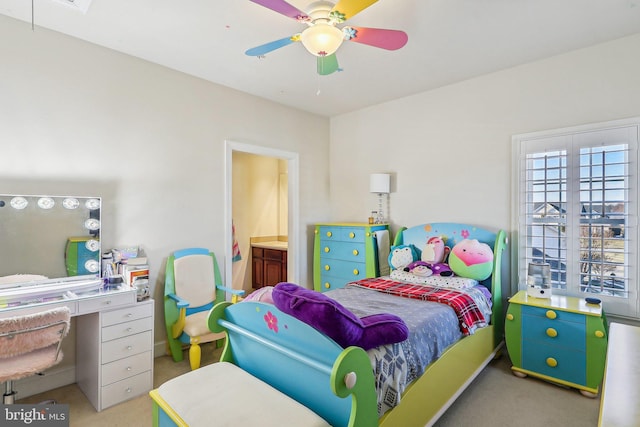 carpeted bedroom with ceiling fan and ensuite bathroom