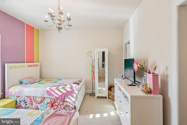 carpeted bedroom featuring a notable chandelier