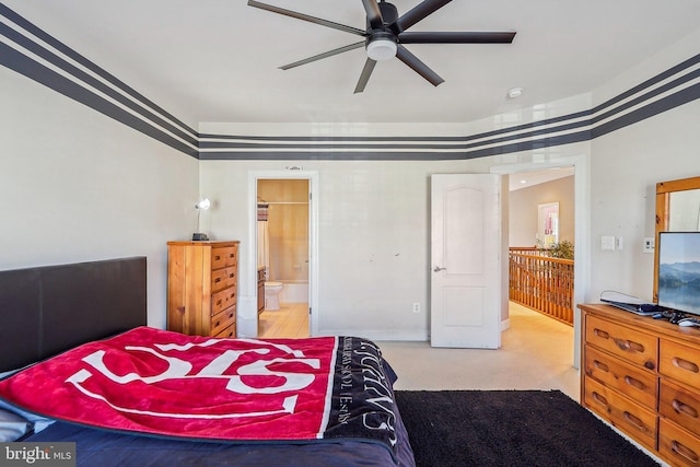 bedroom with light carpet, connected bathroom, and ceiling fan