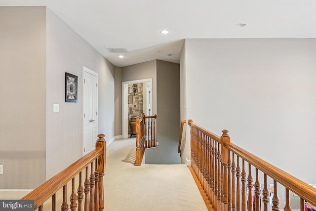 hall featuring light colored carpet