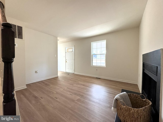 living area featuring wood finished floors and baseboards