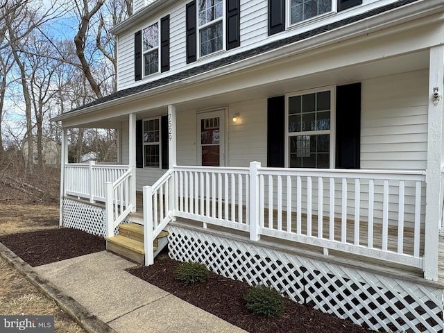 view of exterior entry featuring covered porch