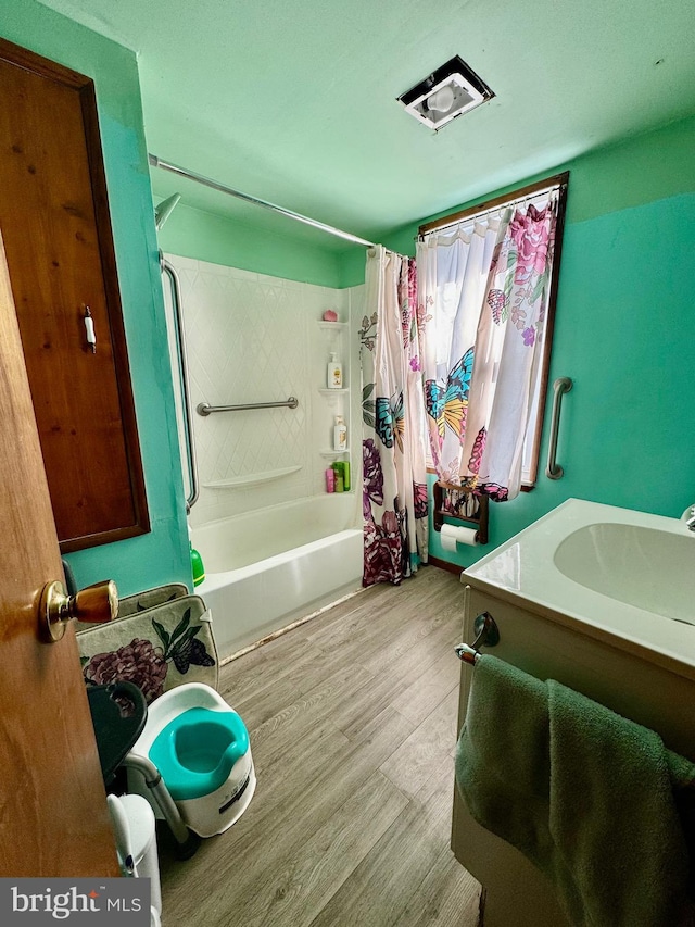 bathroom featuring vanity, hardwood / wood-style flooring, and shower / bath combination with curtain