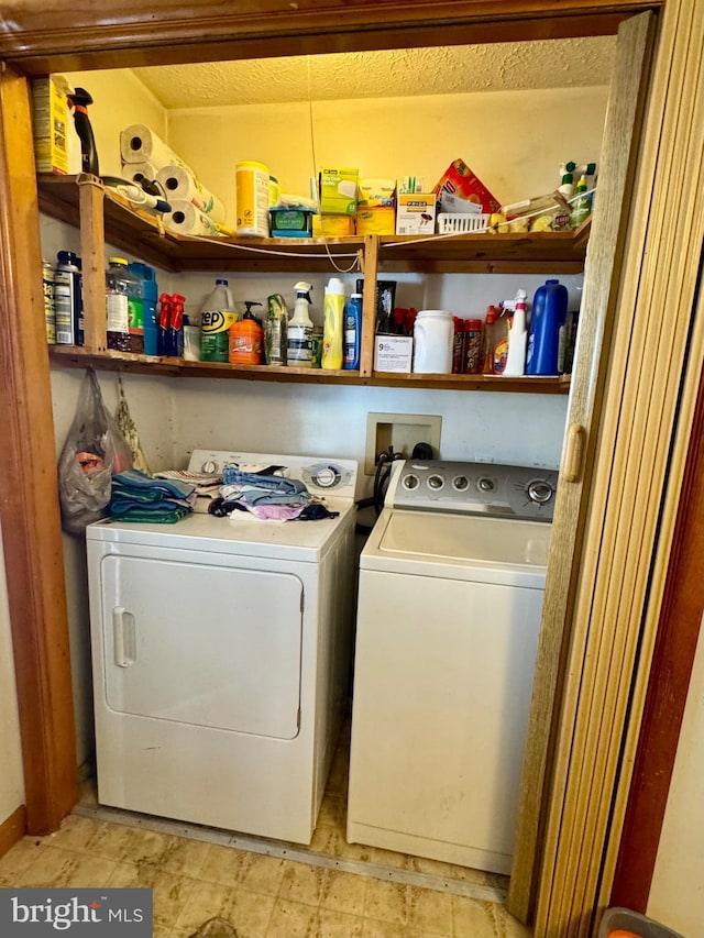 clothes washing area featuring washer and clothes dryer