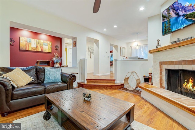 living room with hardwood / wood-style flooring and a tile fireplace