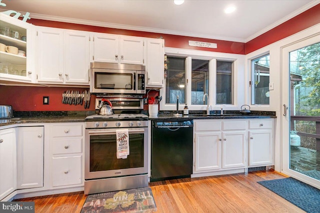 kitchen with sink, light hardwood / wood-style floors, white cabinets, and appliances with stainless steel finishes