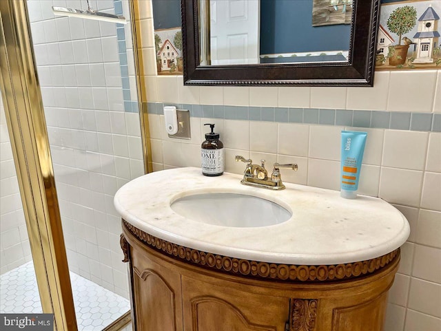 bathroom featuring vanity and tile walls