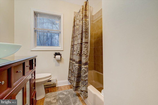 full bathroom featuring shower / bath combo, hardwood / wood-style floors, vanity, and toilet