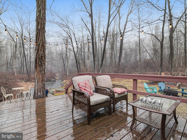 wooden deck featuring a fire pit