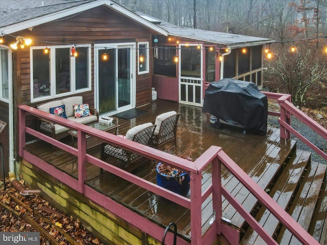 snow covered deck with a sunroom and a grill