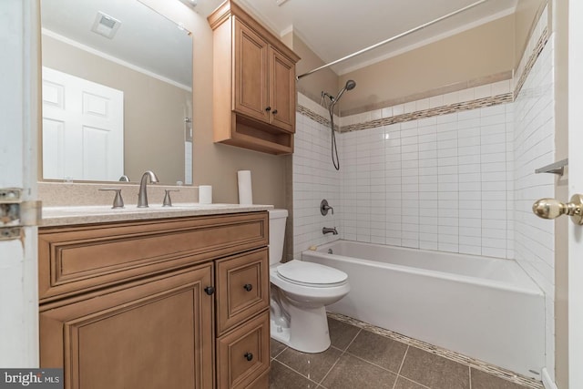 full bathroom featuring tiled shower / bath combo, ornamental molding, vanity, toilet, and tile patterned floors