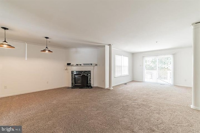 unfurnished living room featuring crown molding, a premium fireplace, and carpet