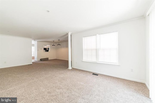 carpeted empty room featuring baseboards, visible vents, and ornamental molding