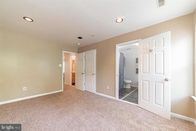 unfurnished bedroom with baseboards, visible vents, connected bathroom, carpet floors, and recessed lighting