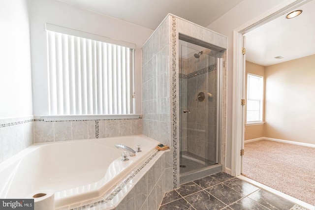 full bathroom featuring visible vents, a garden tub, a shower stall, and baseboards