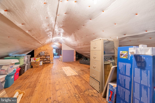 bonus room with vaulted ceiling and light hardwood / wood-style flooring