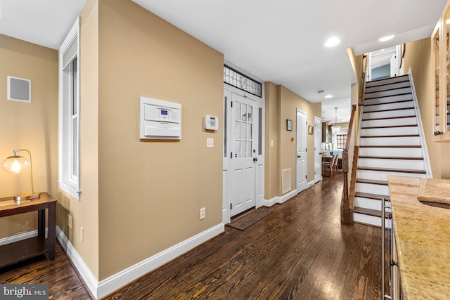 entryway with dark hardwood / wood-style floors