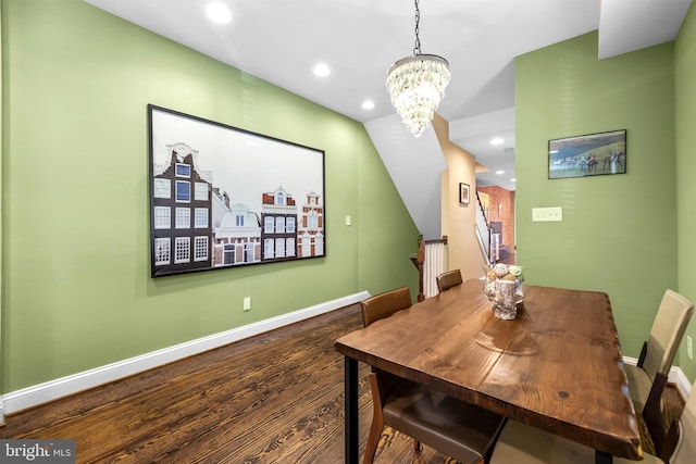 dining area with wood-type flooring and a chandelier