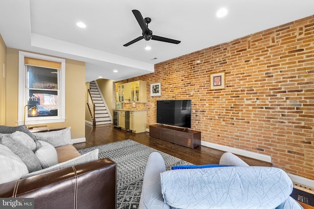 living room with dark wood-type flooring, ceiling fan, brick wall, and beverage cooler