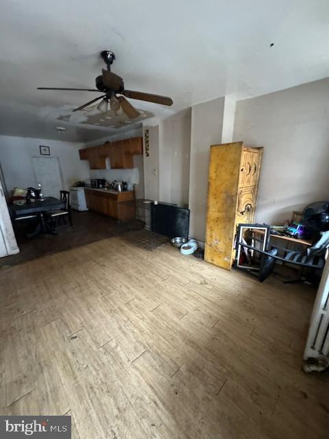 unfurnished living room with hardwood / wood-style floors and ceiling fan