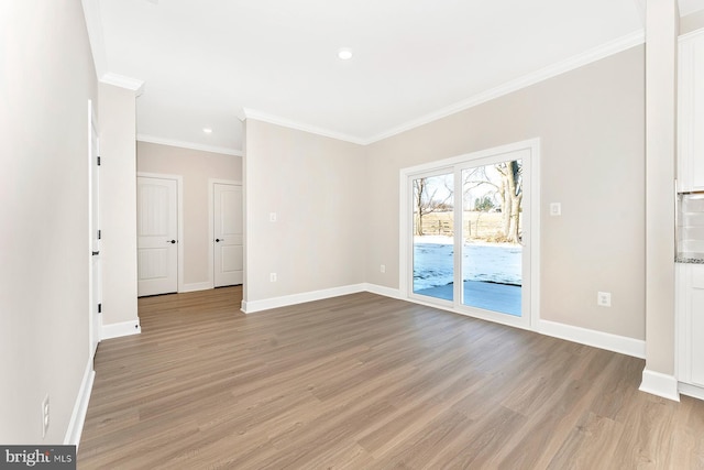 unfurnished room featuring crown molding and light wood-type flooring