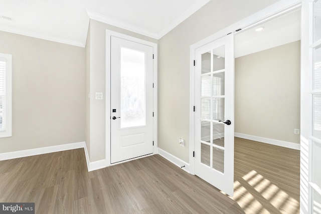 entryway featuring crown molding, hardwood / wood-style flooring, and french doors