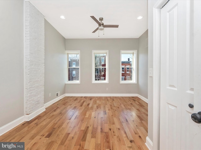 unfurnished room with plenty of natural light, light hardwood / wood-style floors, and ceiling fan