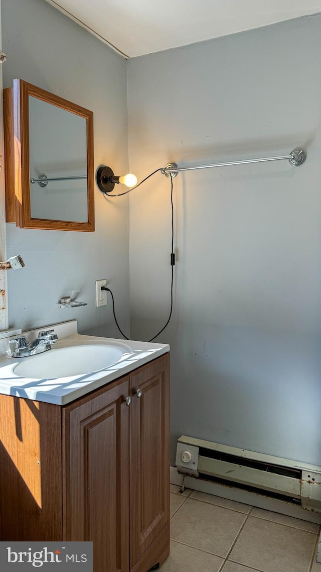 bathroom featuring tile patterned flooring, a baseboard heating unit, and vanity