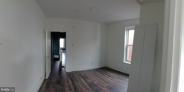 empty room with dark hardwood / wood-style floors