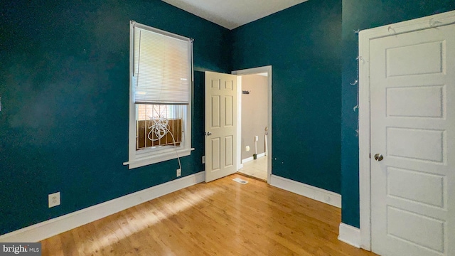 empty room with hardwood / wood-style flooring