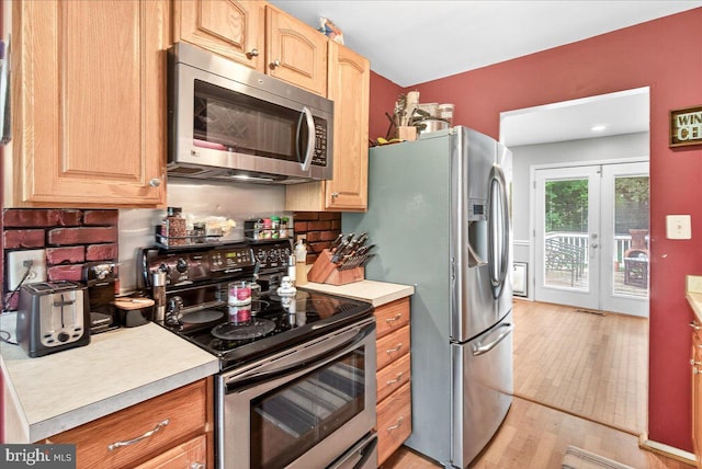 24200 Log House Rd, Gaithersburg, MD 20882 - kitchen with appliances with stainless steel finishes, light countertops, decorative backsplash, light wood finished floors, and light brown cabinets
