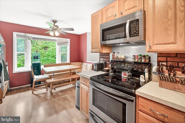 24200 Log House Rd, Gaithersburg, MD 20882 - kitchen featuring appliances with stainless steel finishes, light countertops, ceiling fan, light wood-type flooring, and light brown cabinets