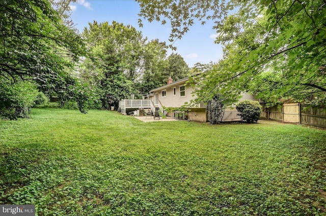 24200 Log House Rd, Gaithersburg, MD 20882 - view of yard featuring a wooden deck and a patio area