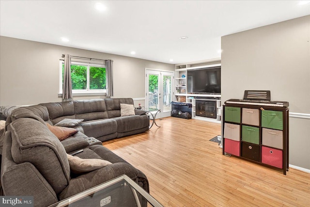 24200 Log House Rd, Gaithersburg, MD 20882 - living area featuring light wood finished floors, a glass covered fireplace, and recessed lighting