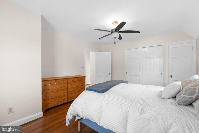 bedroom with a ceiling fan, a closet, baseboards, and dark wood-type flooring