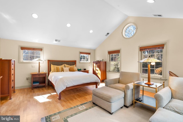 bedroom with light wood finished floors, multiple windows, and visible vents