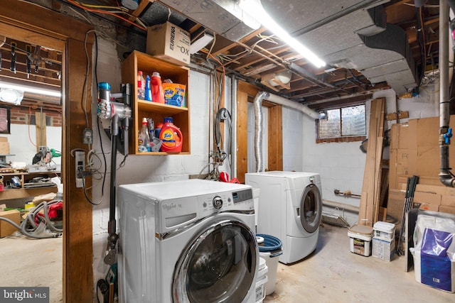 clothes washing area with laundry area and washer and clothes dryer