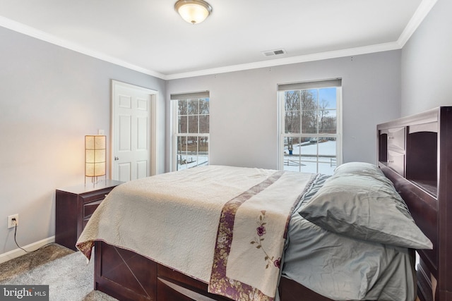 carpeted bedroom with ornamental molding