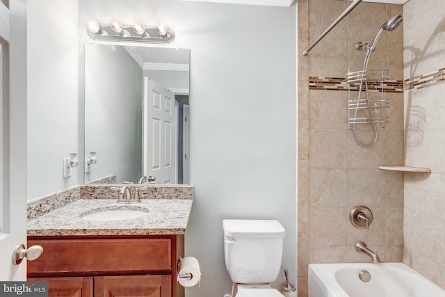 full bathroom featuring vanity, crown molding, toilet, and tiled shower / bath combo