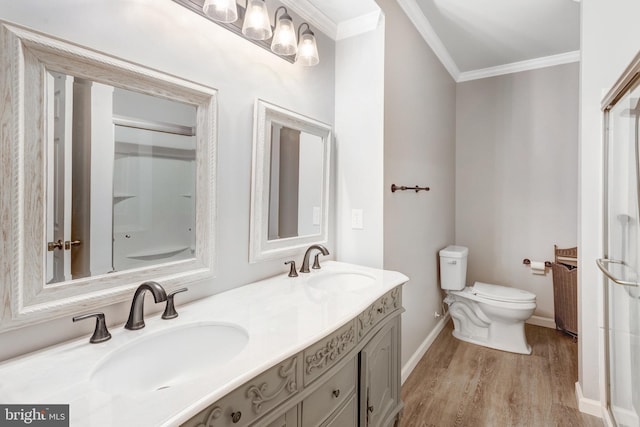 bathroom featuring crown molding, vanity, toilet, and hardwood / wood-style flooring