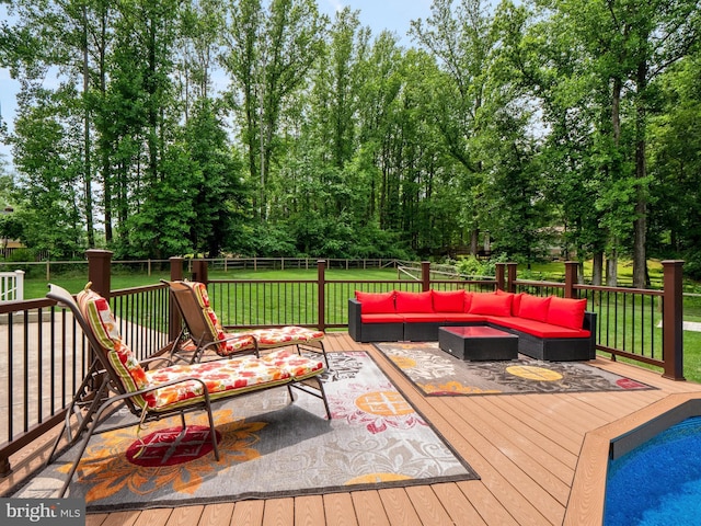 wooden deck featuring a yard and an outdoor hangout area