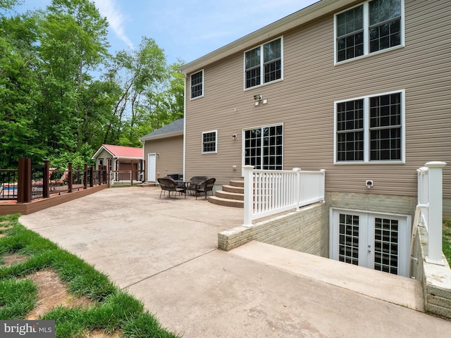 rear view of house featuring a patio and french doors