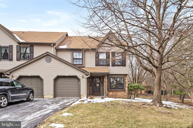 view of front of property with a garage and a front lawn