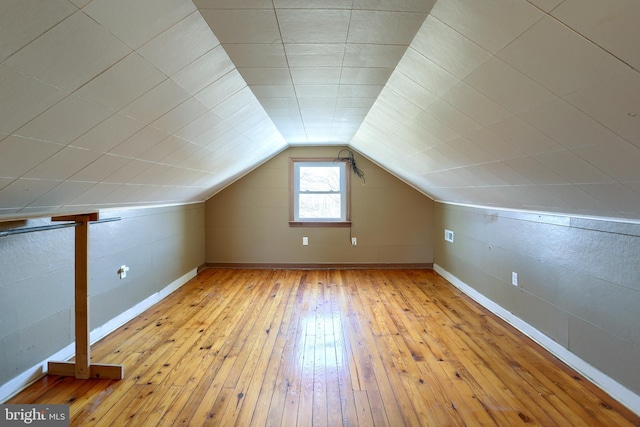 bonus room featuring lofted ceiling and light hardwood / wood-style flooring