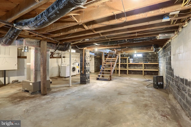 basement with heating unit and independent washer and dryer