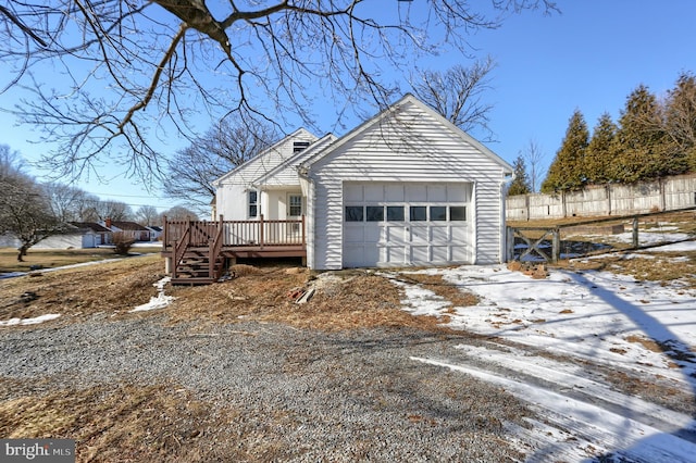 view of snow covered exterior with a deck