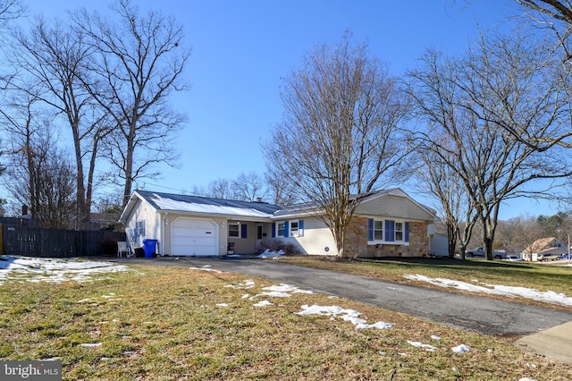 single story home featuring a garage and a front yard