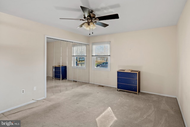 carpeted spare room featuring ceiling fan